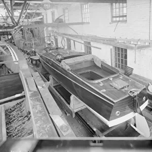 Motor launch in boatyard shed, 1913. Creator: Kirk & Sons of Cowes