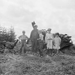 Mrs. Arnold and her children before the stump pile, Michigan Hill, Thurston County, Washington, 1939 Creator: Dorothea Lange