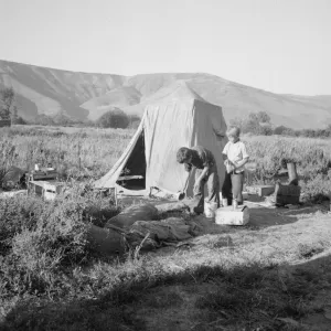 Possibly: Fatherless migratory family camped behind gas station, Yakima Valley, Washington, 1939. Creator: Dorothea Lange