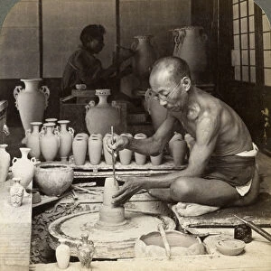 A potter and his wheel, fashioning a vase of Awata porcelain, Kinkosan works, Kyoto, Japan, 1904. Artist: Underwood & Underwood