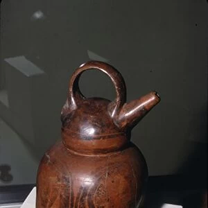Pottery vessel with twin spouts (one missing) and strap-handle, Quimbaya, Columbia, 500-1000