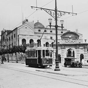 Public tram moving through the streets of Mataro, in front of the Escuelas Pias