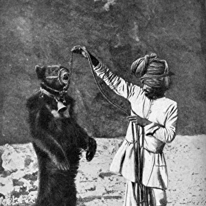 A Punjabi native with a dancing bear, India, 1922. Artist: Robert Chisham