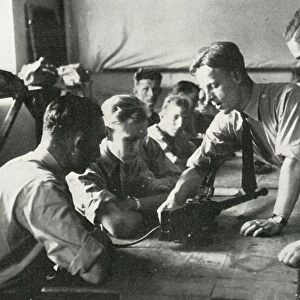 RAF personnel learning about weapons, 1941. Creator: Charles Brown