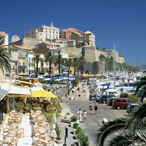 Restaurants in the old port with the Citadel in the background, Calvi, Corsica