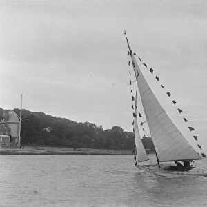 Saling yacht Asphodel (K5) with prize flags, 1922. Creator: Kirk & Sons of Cowes