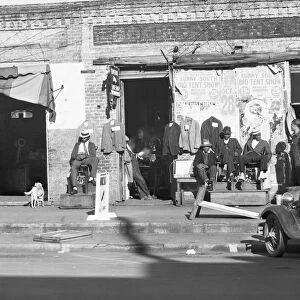 Sidewalk scene in Selma, Alabama, 1935. Creator: Walker Evans