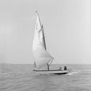 Snowdrop sailing under spinnaker, 1911. Creator: Kirk & Sons of Cowes