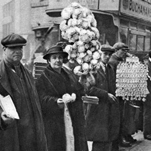 Street hawkers selling football favours in Walham Green, London, 1926-1927