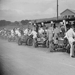Triumph and Riley cars in the pits at the RAC TT Race, Ards Circuit, Belfast, 1929 Artist
