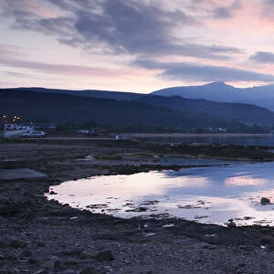 View across Brodick Bay to Beinn Tarsuinn and Goatfell at sunset, Arran, North Ayrshire, Scotland