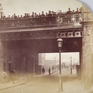 View of figures looking over the south side of Shoe Lane Bridge, City of London, 1869