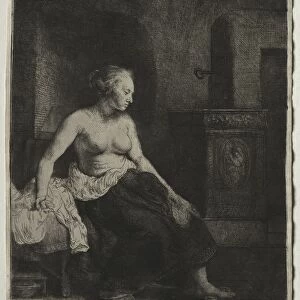 Woman Sitting Half Dressed Beside a Stove, 1658. Creator: Rembrandt van Rijn (Dutch, 1606-1669)