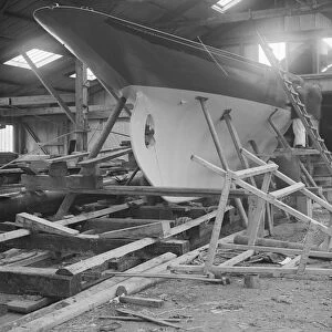 The yawl Banzai in shed at boatyard, 1912. Creator: Kirk & Sons of Cowes