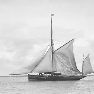 The yawl Roma raising main sail, 1912. Creator: Kirk & Sons of Cowes