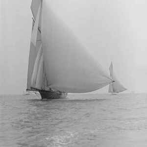 The yawl Wendur sailing with spinnaker, 1913. Creator: Kirk & Sons of Cowes