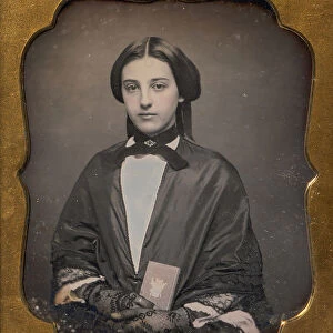 Young Woman Wearing Lace Gloves Holding a Daguerreotype Case, 1860s. Creator: Unknown