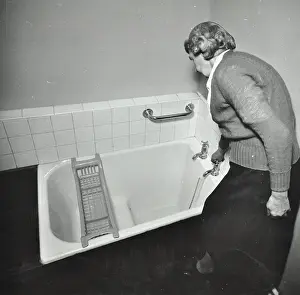 Poplar Tower Hamlets London England Prints: 16 Candy Street, Poplar, London: elderly woman in bathroom, 1962. Creator: Unknown