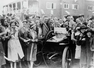 Evans Prints: A 1904 Wolseley amidst a crowd of cheering people