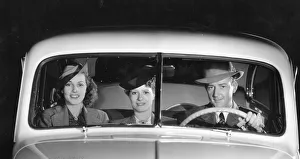 Split Windscreen Prints: 1939 Oldsmobile driver and female passengers. Creator: Unknown