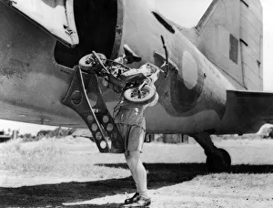 1944 Prints: 1944 Welbike being placed on to military transport plane. Creator: Unknown
