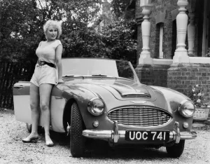 Austin Healey Prints: 1957 Austin - Healey 100-6 with model. Creator: Unknown