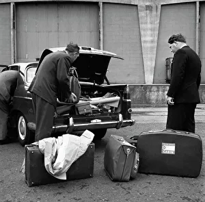 Suitcase Prints: A 1961 Austin Westminster being loaded with luggage on Amsterdam docks, Netherlands 1963