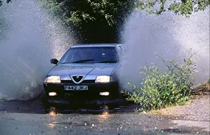 Splash Prints: 1989 Alfa Romeo 164 driving through a ford