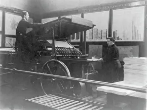 Maps Prints: 2 men operating map printing press at U
