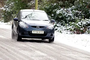 Dangerous Driving Conditions Prints: 2009 Mazda 2 driving on snowy road