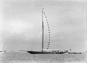 The 221 ton cutter Britannia at anchor with prize flags, 1921
