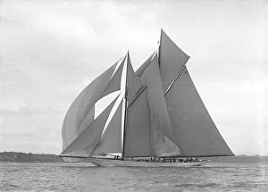 The 250 ton schooner Germania sails downwind under spinnaker, 1911