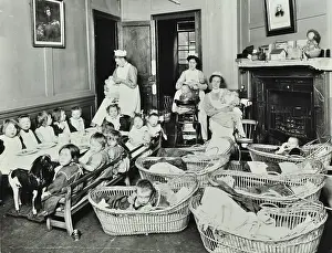 Caring Prints: 30 Albury Street; Nursey at dinner time, Children in Baskets, 1911. Creator: Unknown