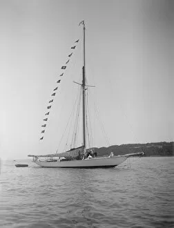 The 40-rater cutter Carina at anchor with flags, 1911. Creator: Kirk & Sons of Cowes