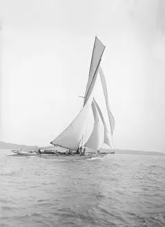 The 40-rater cutter Carina sailing on a reach, 1911. Creator: Kirk & Sons of Cowes