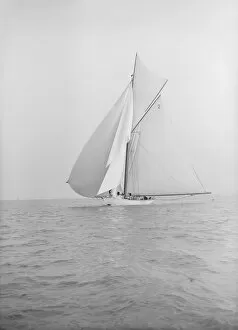 The 40-rater cutter Carina sailing with spinnaker, 1913. Creator: Kirk & Sons of Cowes