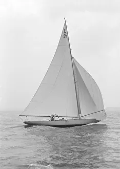 The 6 Metre Lanka sailing with spinnaker, 1914. Creator: Kirk & Sons of Cowes