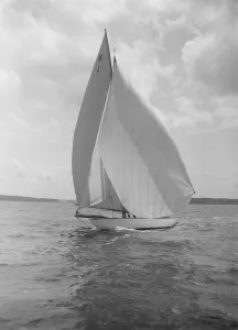 The 7 Metre Marsinah (K1) sailing with spinnaker, 1912. Creator: Kirk & Sons of Cowes