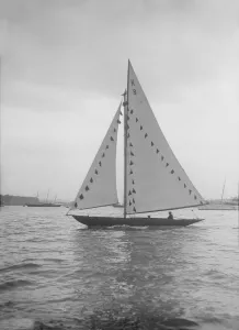 The 7 Metre sailing yacht Pinaster (K8) with prize flags, 1912