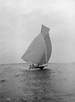 Cutter Gallery: The 8 Metre class Antwerpia IV sailing under spinnaker, 1912. Creator: Kirk & Sons of Cowes