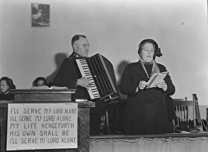 Accordionist Gallery: Adjutant and his wife sing, Salvation Army, San Francisco, California, 1939. Creator: Dorothea Lange