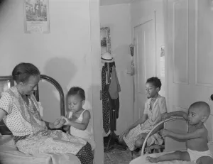 Parks Gordon Roger Alexander Buchanan Collection: Adopted daughter and two grandchildren with Mrs. Ella Watson...charwoman, Washington, D.C, 1942