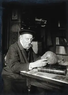 Adrien de Mortillet, holding a skull. Creator: Unknown