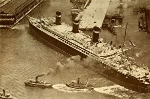 Liner Gallery: An Aerial Photograph of the Leviathan Being Towed By Small Tugs Into