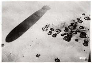 Aerial view of a desert settlement, with a shadow cast by a Zeppelin, 1931 (1933)