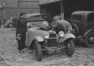 Car Maintenance Gallery: AES Curtis looking under the bonnet of his HRG at the RAC Rally, 1939. Artist: Bill Brunell