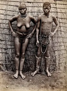 Africa: an African woman and man in front of a kraal hut, 19th century. Creator: Unknown