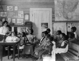Cotton Prints: African American children and teacher in classroom studying