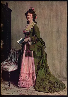 An afternoon dress of green and pink silk. Very typical of the modes between 1868 and 1878, c1913 An afternoon dress of green and pink silk. Very typical of the modes between 1868 and 1878, c1913
