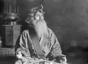 Aino Prints: Ainu chief wearing a headdress seated with a sword in his lap